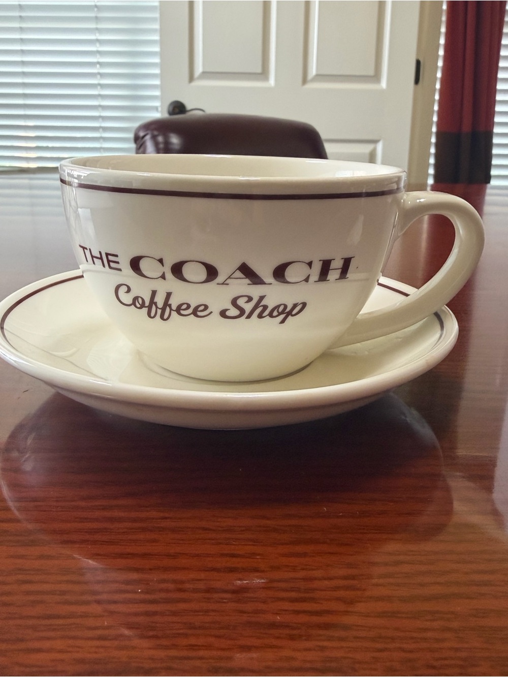 Coach White Ceramic Cup & Saucer with Brown Logo Trim